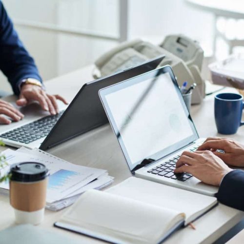 side-view-cropped-unrecognizable-business-people-working-common-desk